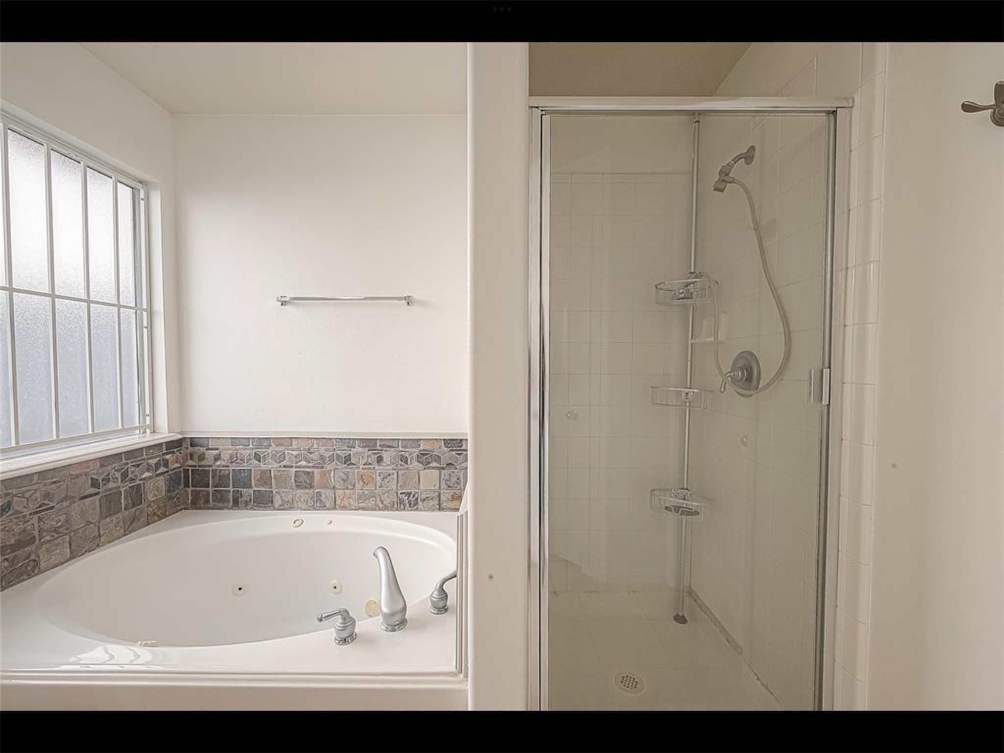 10819 Waterfern Court Houston, TX 77064 - Photo 16 of 37 a bathroom with a bathtub and a shower