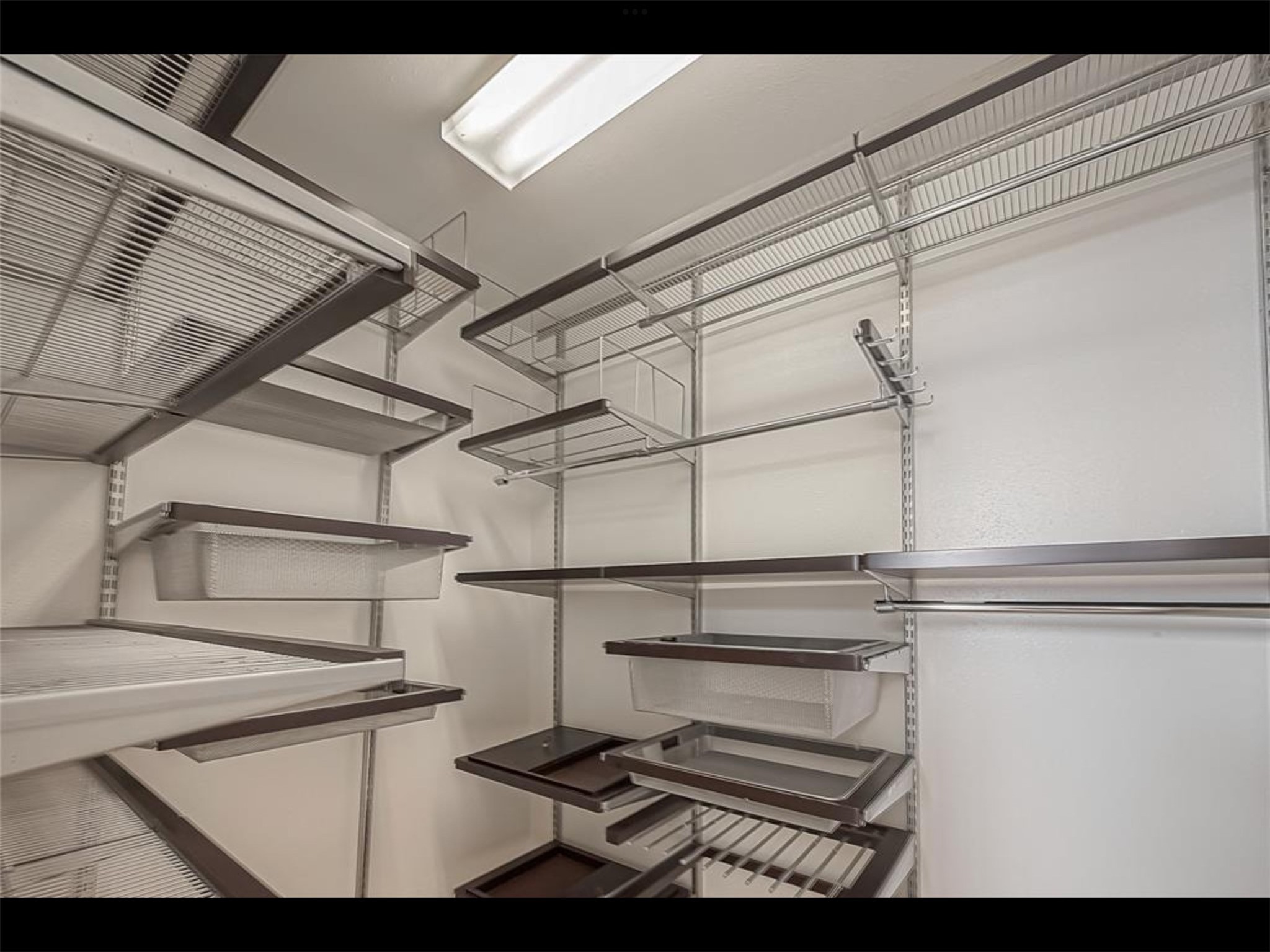 10819 Waterfern Court Houston, TX 77064 - Photo 21 of 37 a view of storage and utility room with racks on the wall