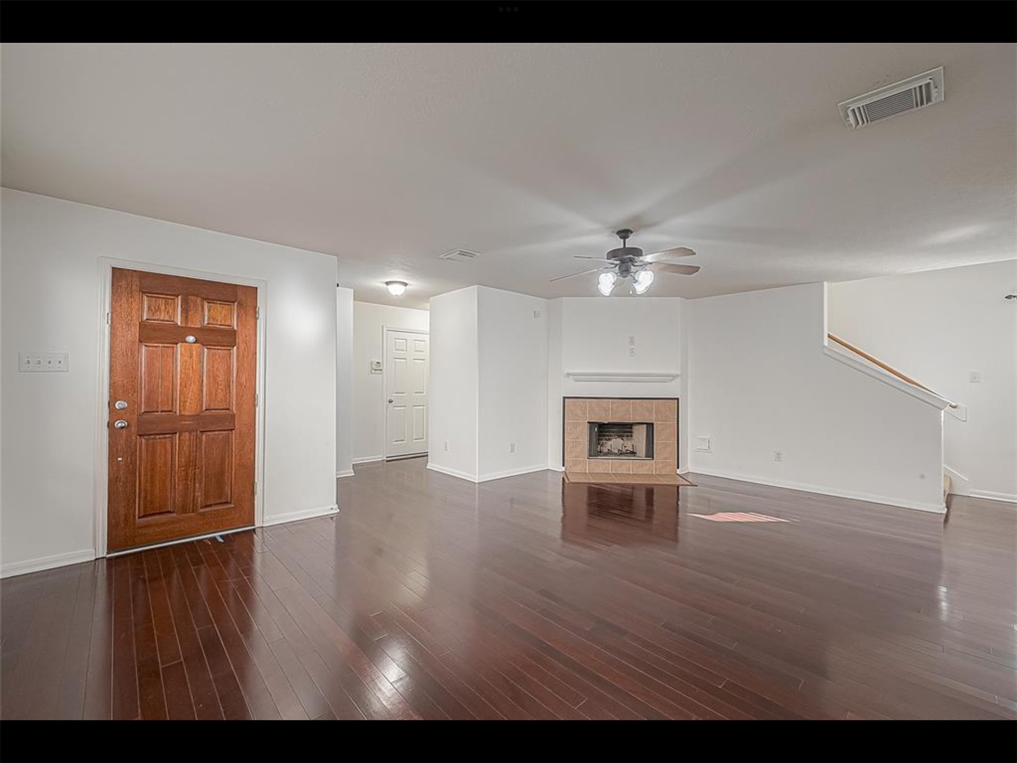 10819 Waterfern Court Houston, TX 77064 - Photo 5 of 37 a view of an empty room with wooden floor and a ceiling fan