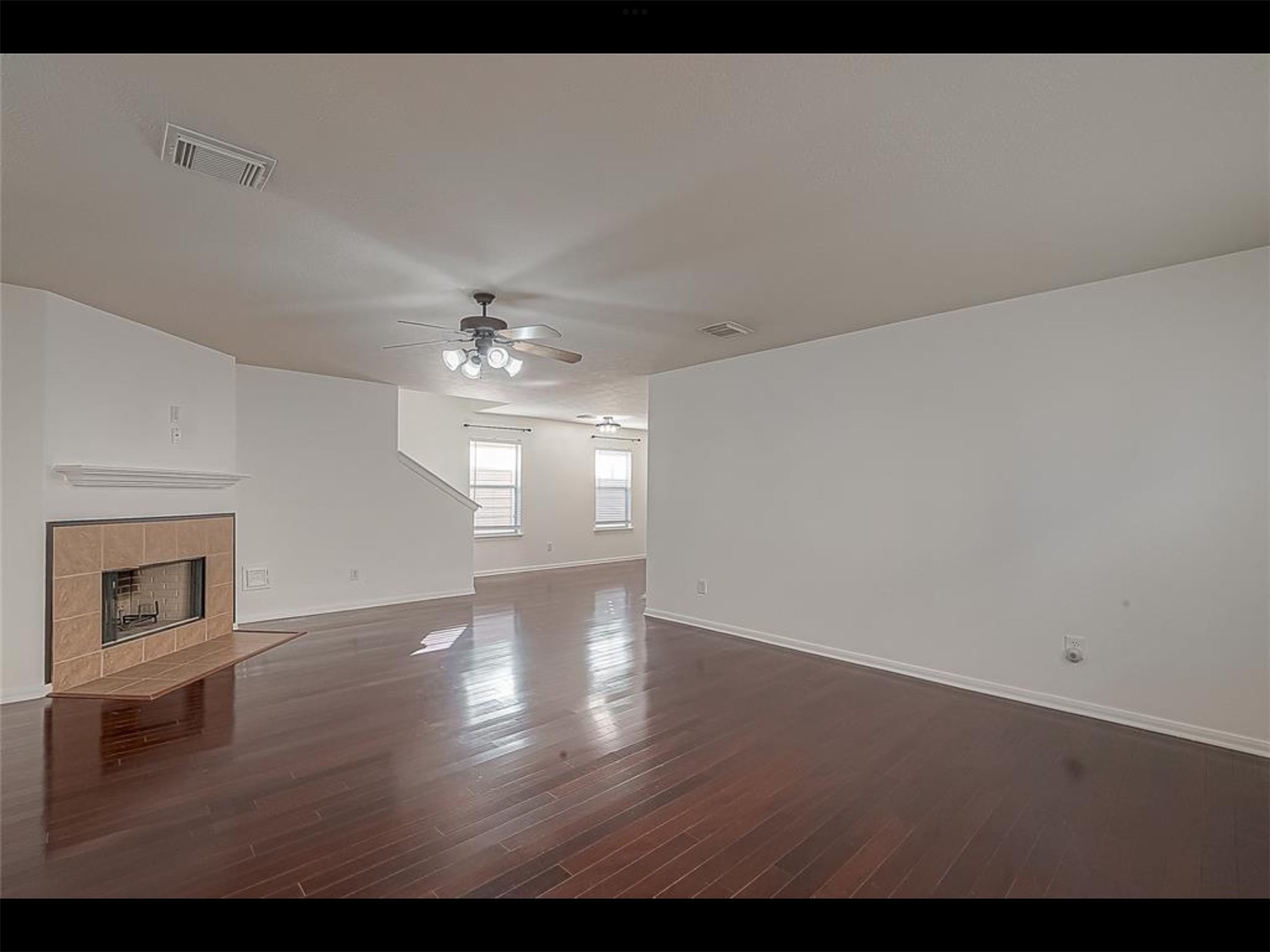 10819 Waterfern Court Houston, TX 77064 - Photo 6 of 37 a view of an empty room with wooden floor fireplace and a window