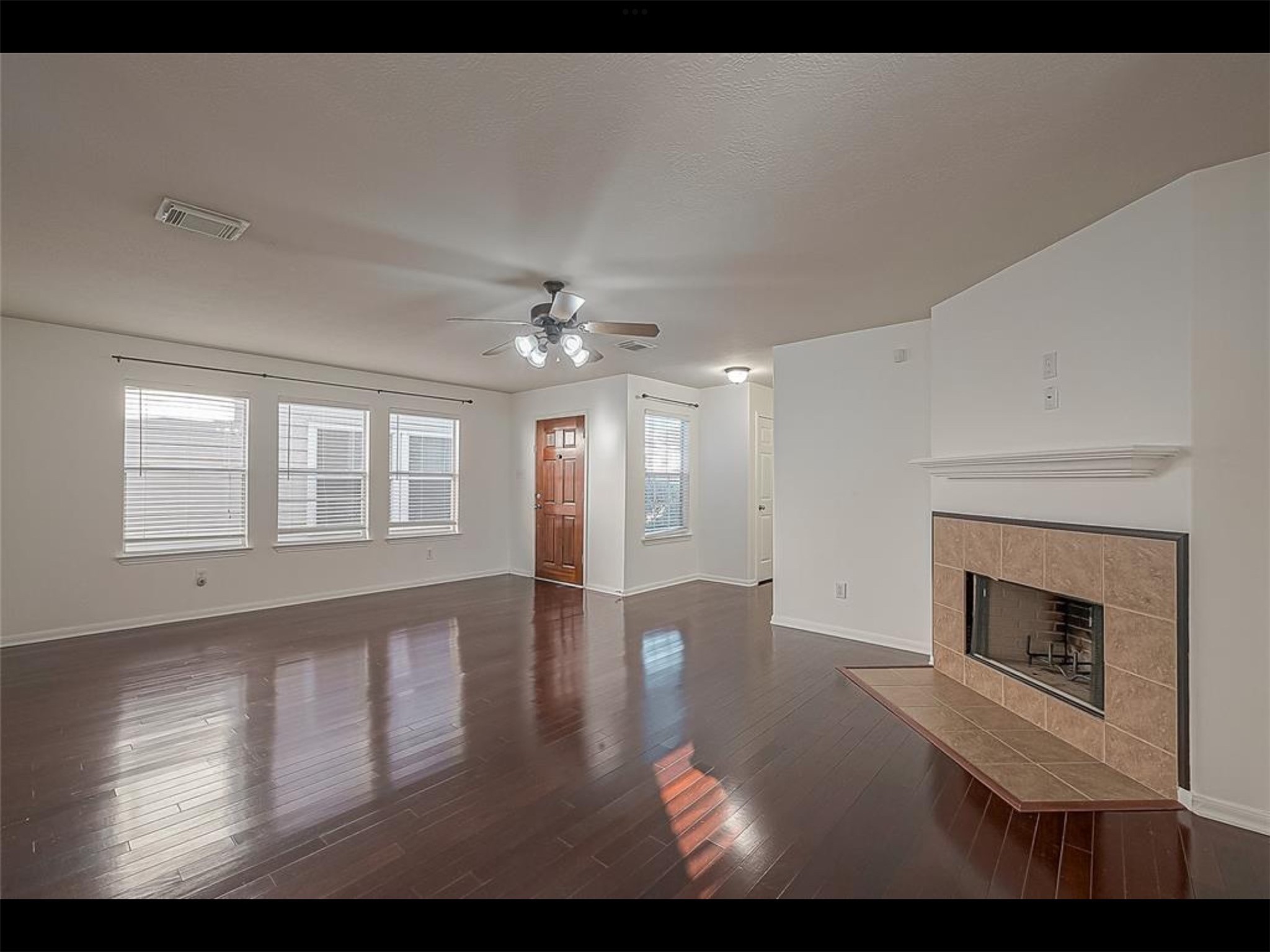10819 Waterfern Court Houston, TX 77064 - Photo 7 of 37 a view of an empty room with chandelier and wooden floor