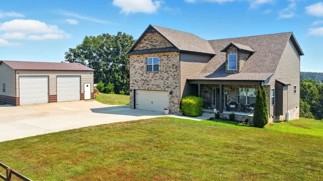 a front view of a house with a yard and garage