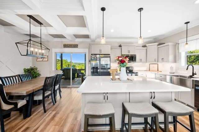 a kitchen with a sink white cabinets and white appliances