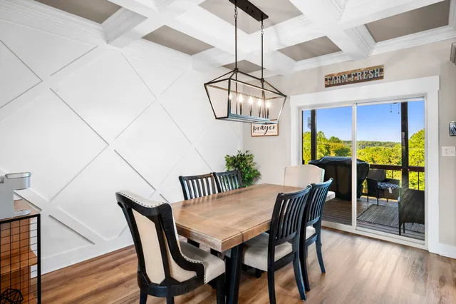 a bedroom with a bed and a dresser with wooden floor