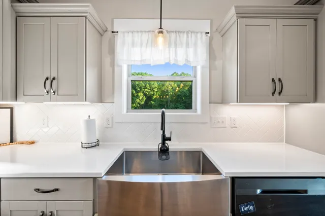 a bedroom that has a bed and a chandelier