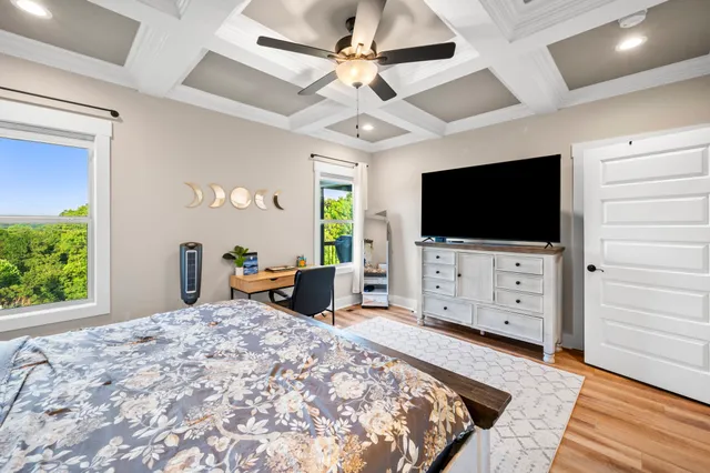 a bedroom with furniture and a flat screen tv