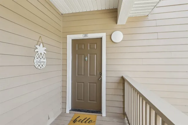 a view of wooden door and a window