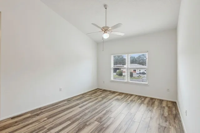 wooden floor in an empty room with a window