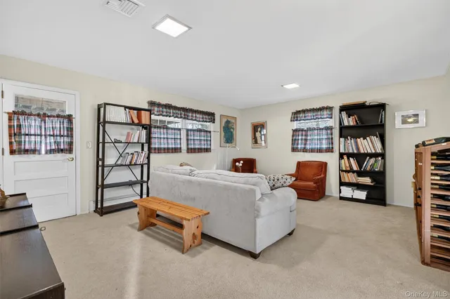 a living room with furniture a bookshelf and a book shelf