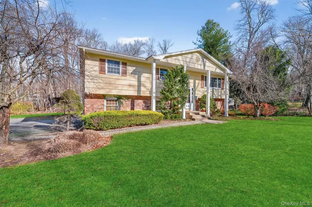 a front view of house with yard and green space