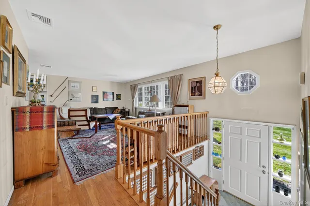 a view of a livingroom with furniture and staircase