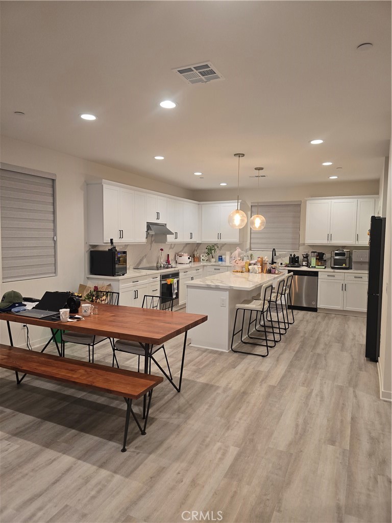 10901 Montauk Lane Stanton, CA 90680 - Photo 1 of 21 a living room with stainless steel appliances kitchen island granite countertop a dining table chairs and a refrigerator
