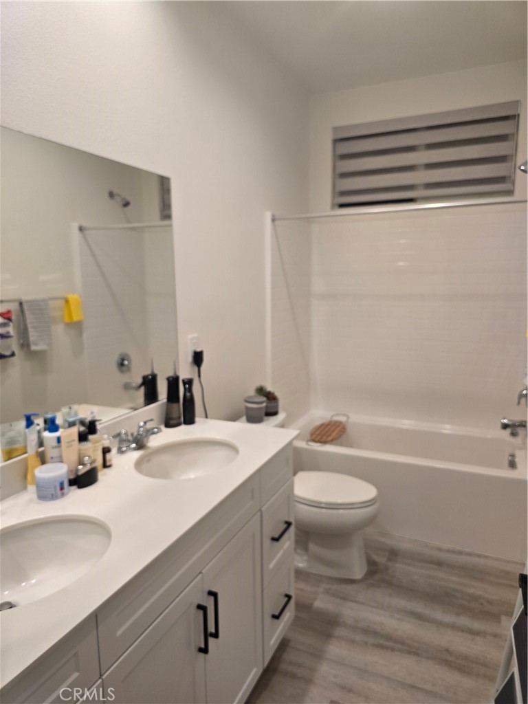 10901 Montauk Lane Stanton, CA 90680 - Photo 11 of 21 a bathroom with a double vanity sink toilet and a bathtub