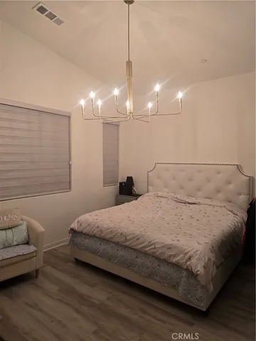 a bedroom with a bed window and couch