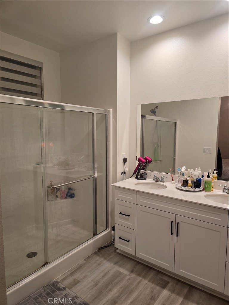 10901 Montauk Lane Stanton, CA 90680 - Photo 13 of 21 a bathroom with a double vanity sink mirror and shower