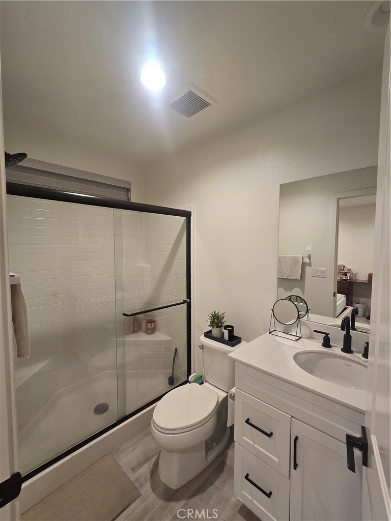 10901 Montauk Lane Stanton, CA 90680 - Photo 16 of 21 a bathroom with a shower sink vanity mirror and toilet