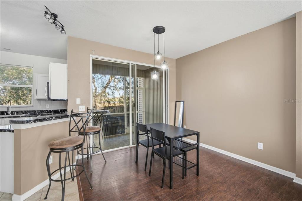 11008 Black Swan Court Seffner, FL 33584 - Photo 9 of 32 a dining room with furniture a chandelier and wooden floor