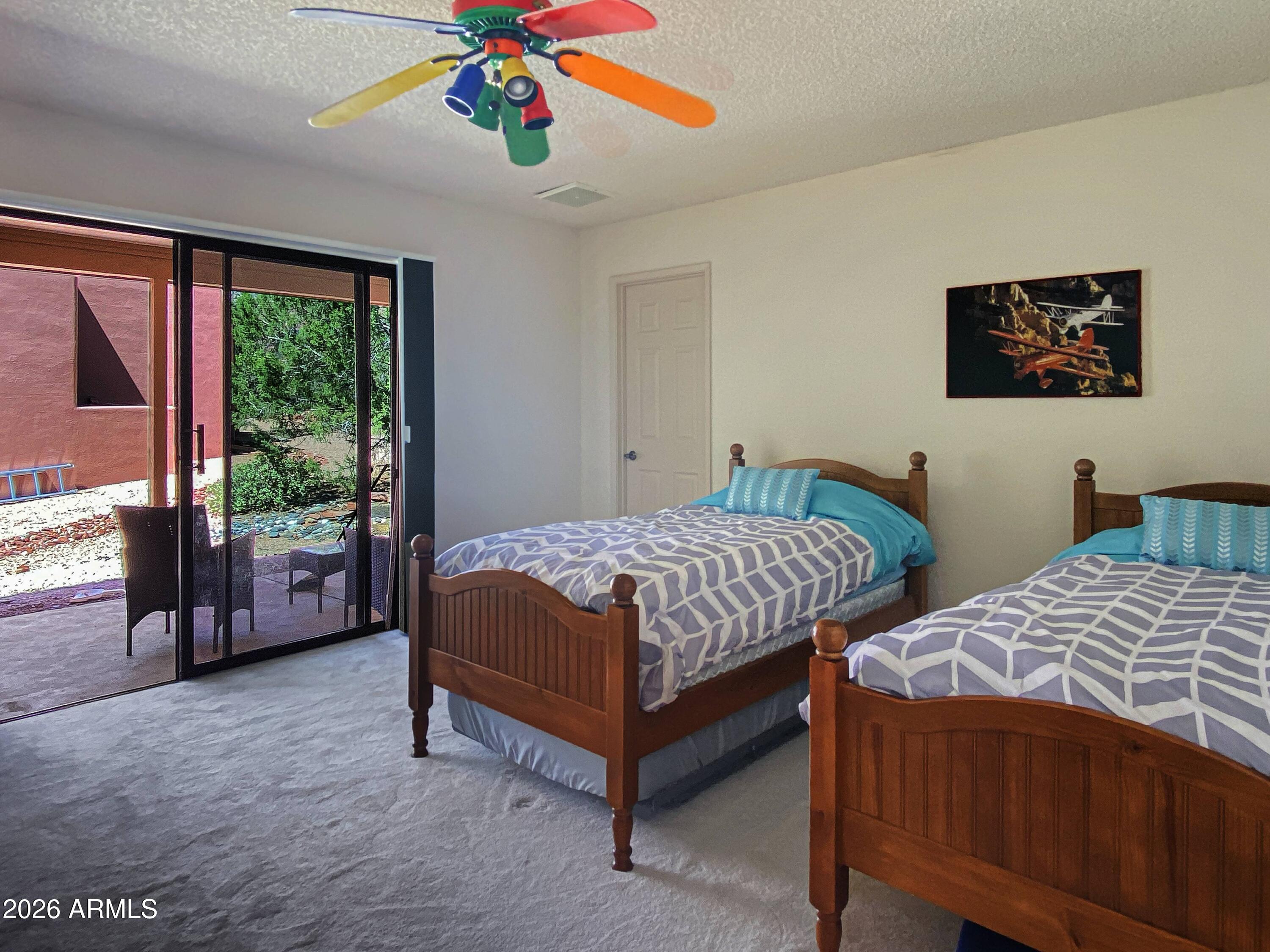 550 Barcelona Road Sedona, AZ 86336 - Photo 22 of 32 a bedroom with a bed and a chandelier