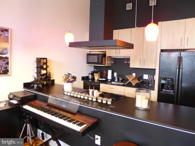 a kitchen with a refrigerator a stove and a sink