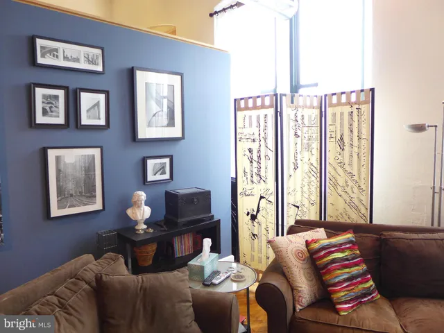 a living room with furniture and large window