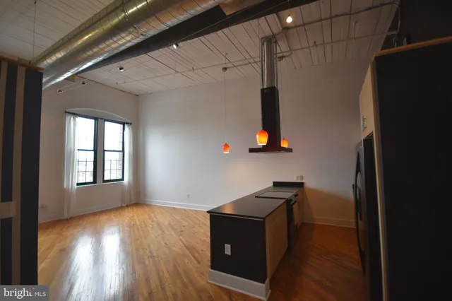 a room with wooden floor and window