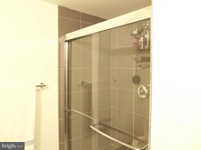 a bathroom with a shower and a mirror