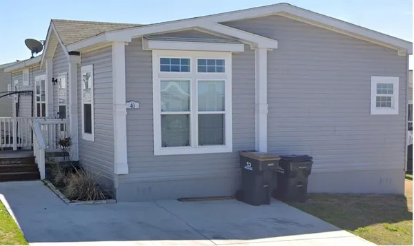 a view of a brick house with many windows