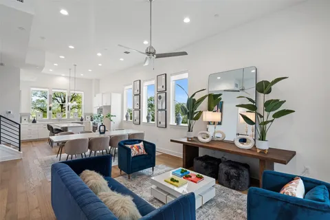 a living room with lots of furniture and view of kitchen