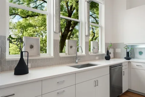 a kitchen with a sink and large window