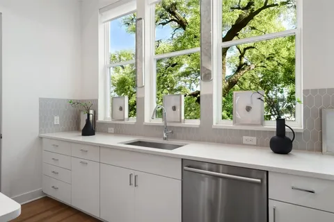a kitchen with a sink and large window