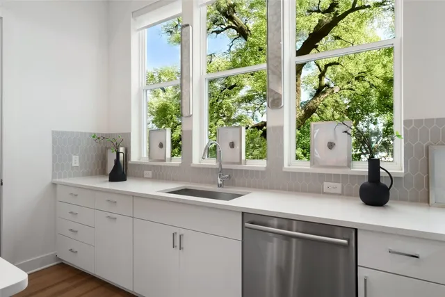 a kitchen with a sink and large window