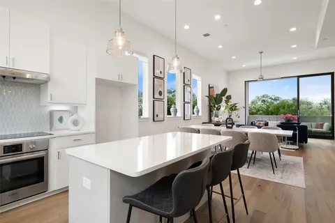 a large kitchen with a table and chairs