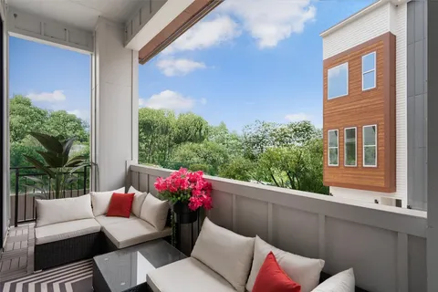 a outdoor living room with furniture and a potted plant
