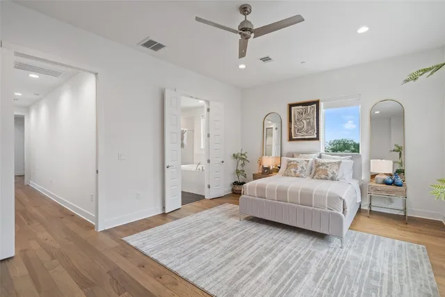 a spacious bedroom with a bed and a walk in closet