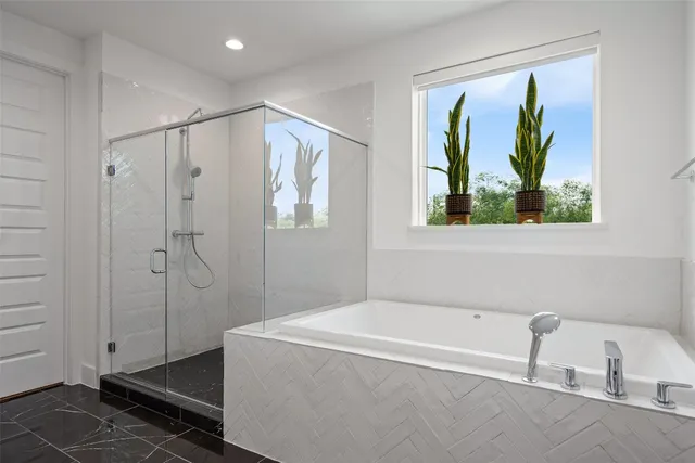 a bathroom with a tub and a shower