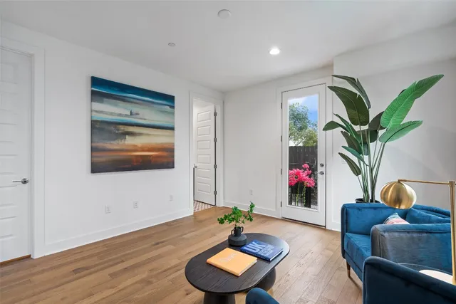 a living room with furniture and a potted plant
