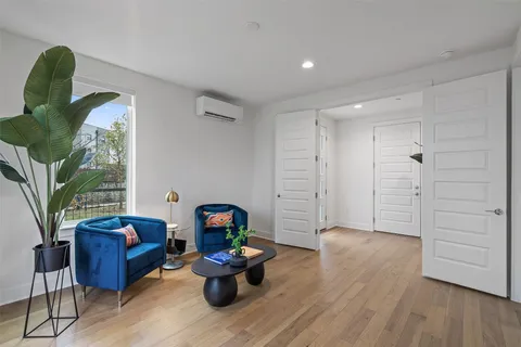a living room with furniture and a wooden floor