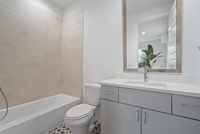 a bathroom with a sink a toilet and a bathtub