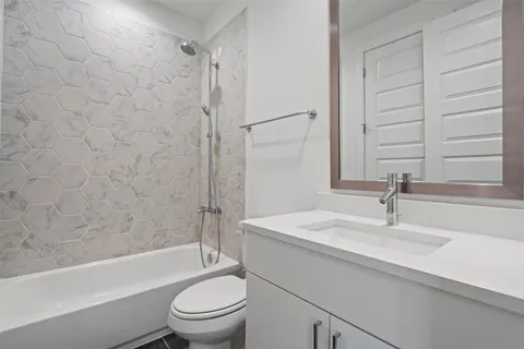 a bathroom with a sink a toilet and a bathtub