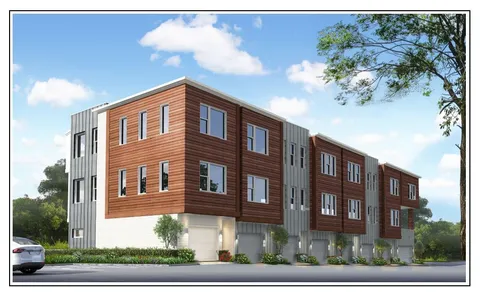 a yellow building with trees in front of it