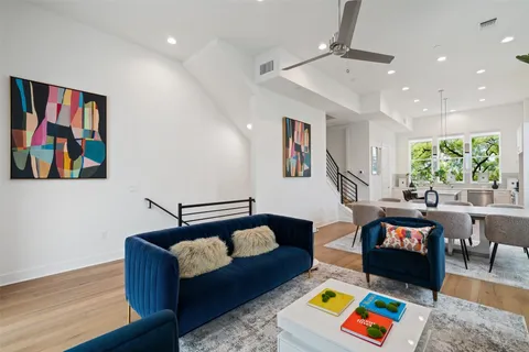 a living room with furniture and painting on the wall