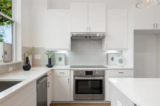 a kitchen with a stove and a white cabinets