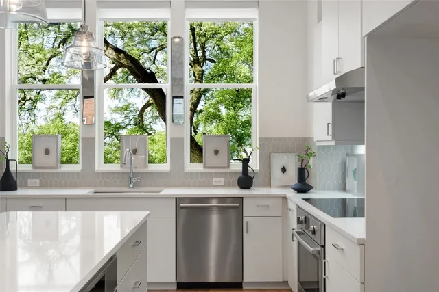 a kitchen with a sink and a large window