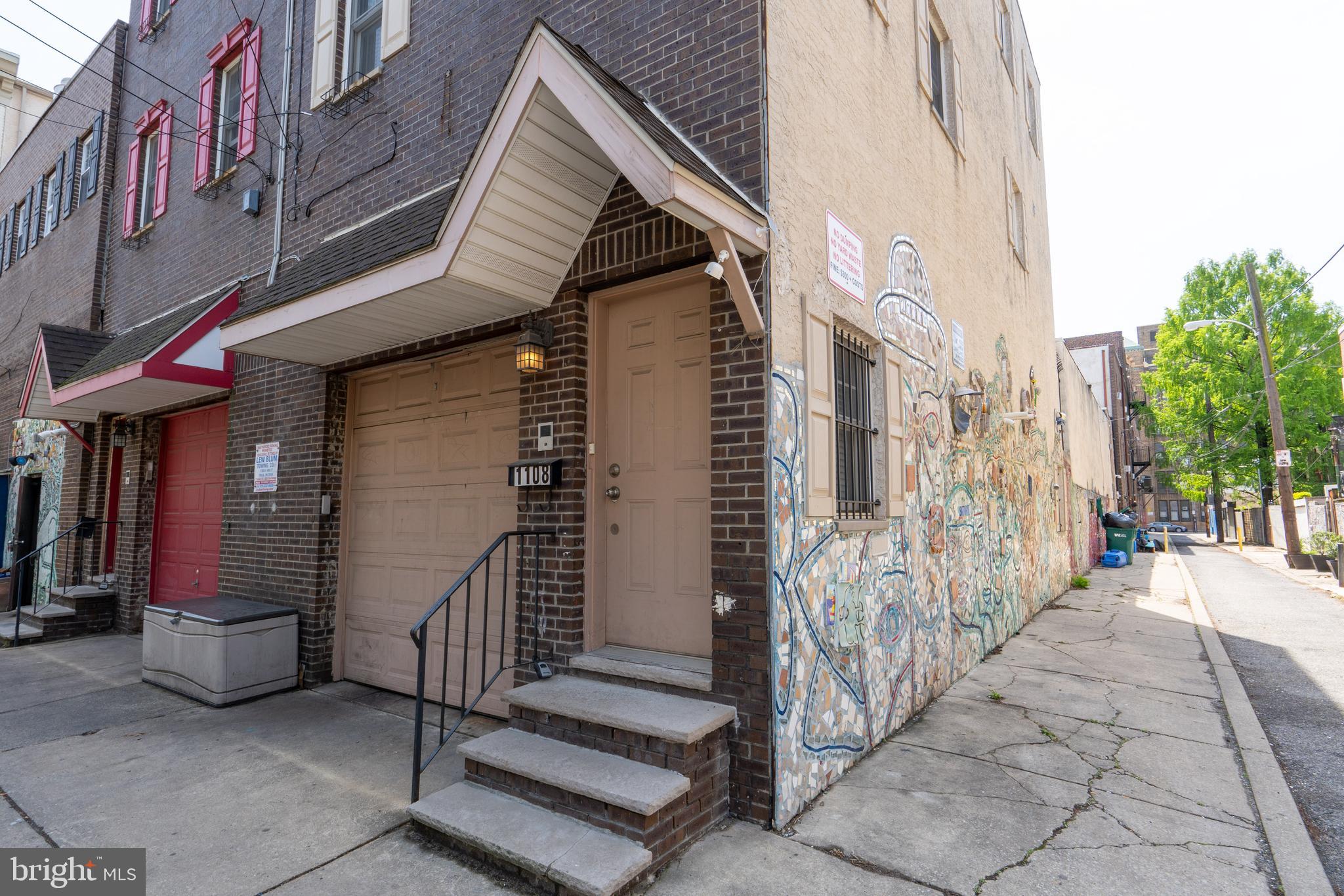 1108 Fitzwater Street Philadelphia, PA 19147 - Photo 1 of 25 a view of a house with a small yard and stairs