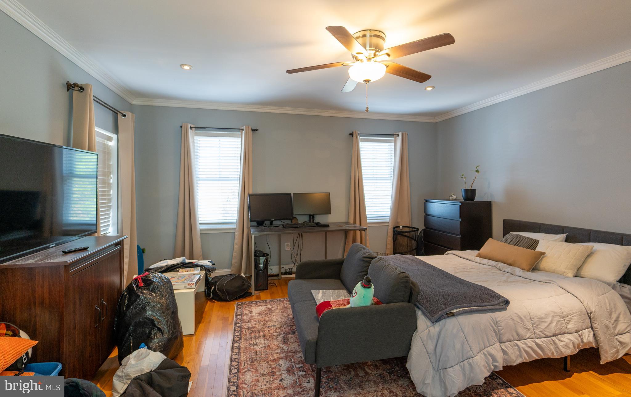 1108 Fitzwater Street Philadelphia, PA 19147 - Photo 12 of 25 a bedroom with a bed and a flat screen television