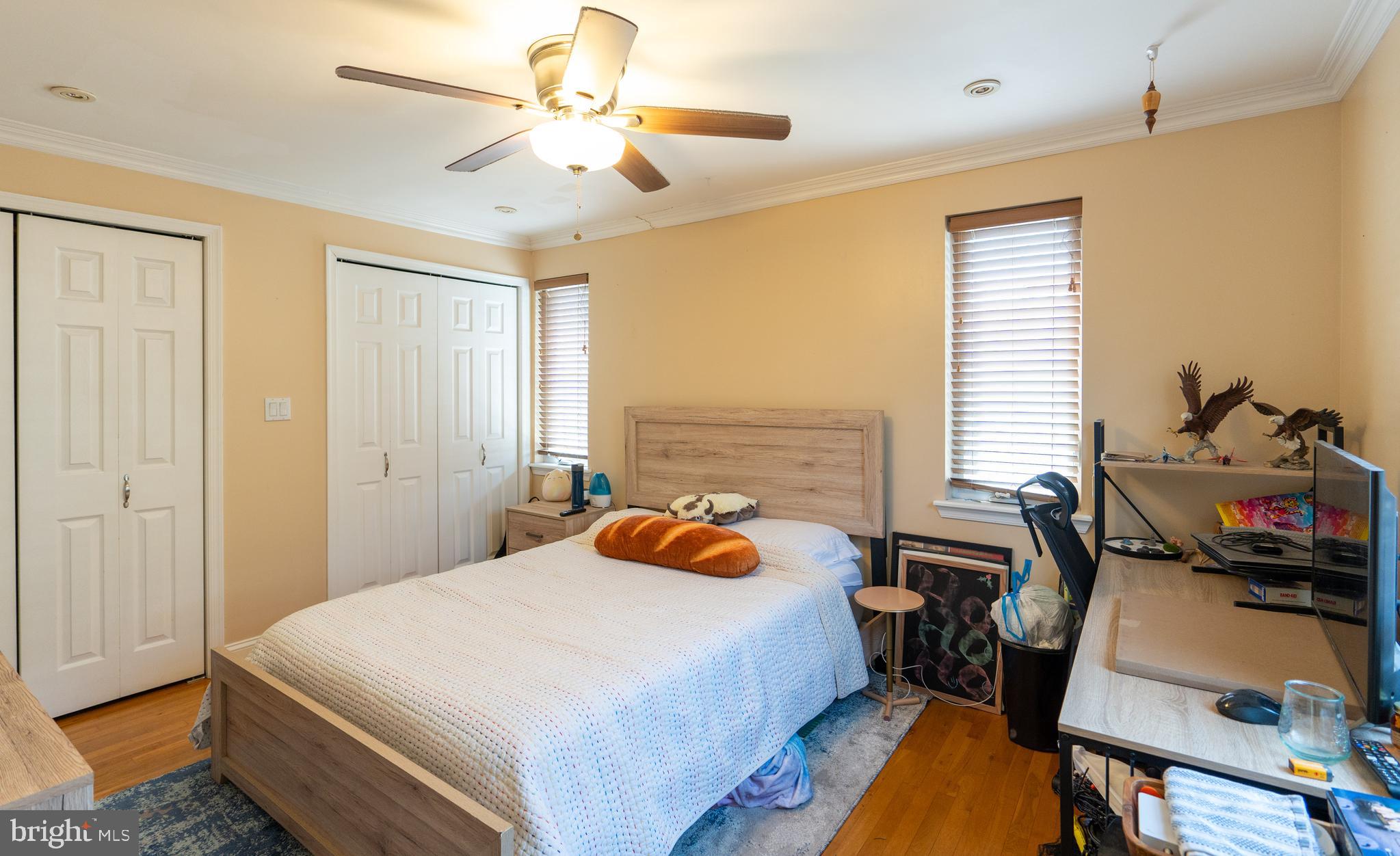1108 Fitzwater Street Philadelphia, PA 19147 - Photo 17 of 25 a bedroom with a bed a chair and a chandelier
