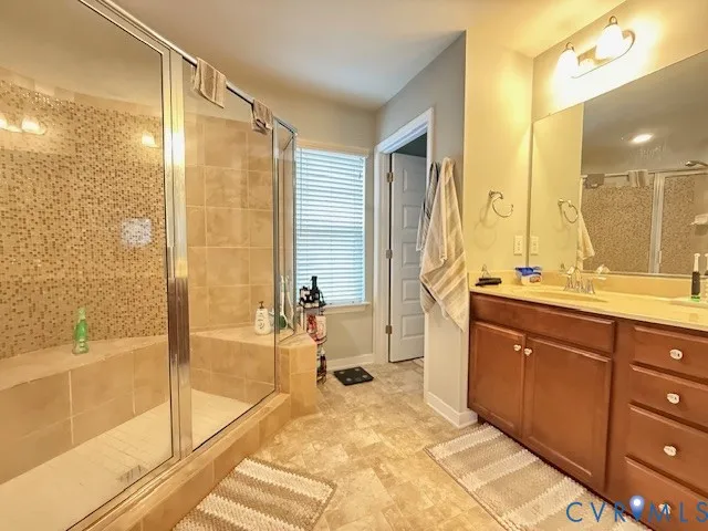 a spacious bathroom with a tub sink and mirror