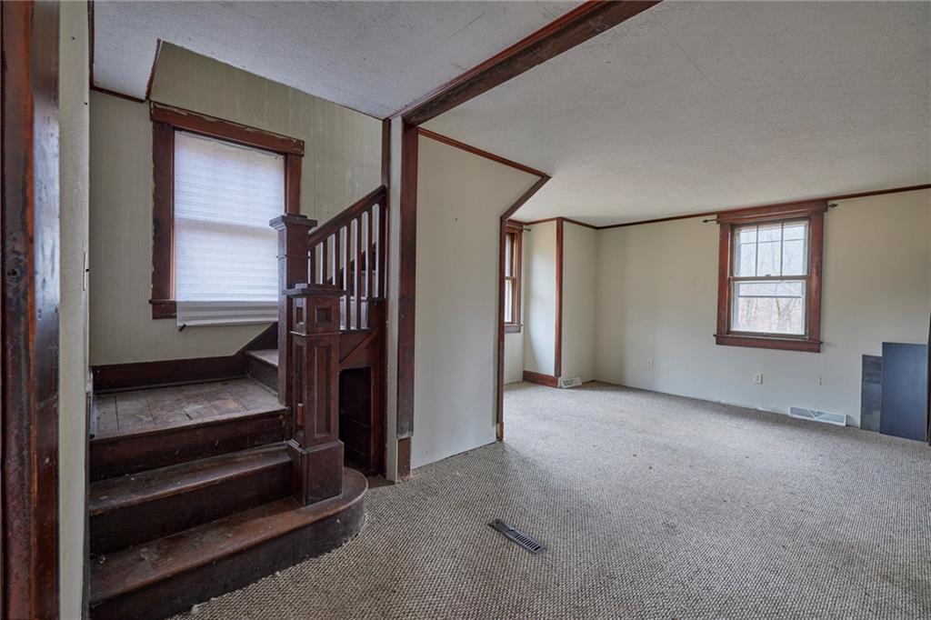 166 McCleary Road Aliquippa, PA 15001 - Photo 3 of 17 a view of hallway with stairs and wooden floor