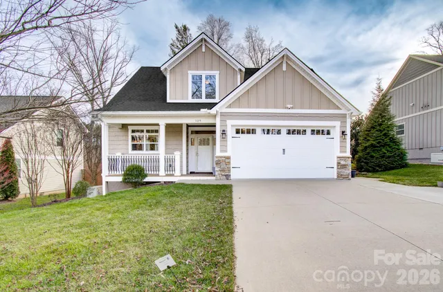 a view of a house with a yard and garage