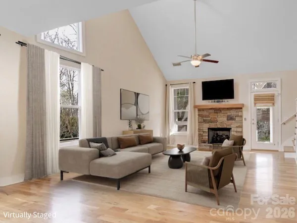 a living room with furniture a fireplace and a flat screen tv